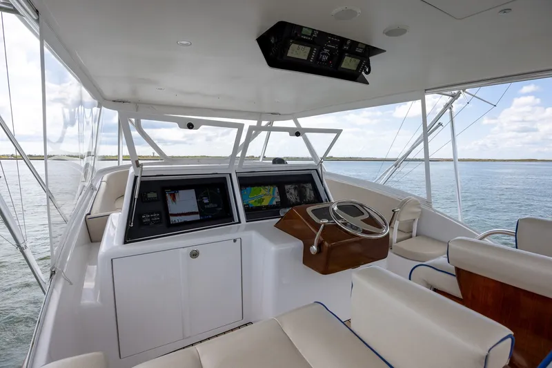 Slide: The Image of Helm of 2008 B&D Convertible yacht with navigation screens and steering wheel. - 57