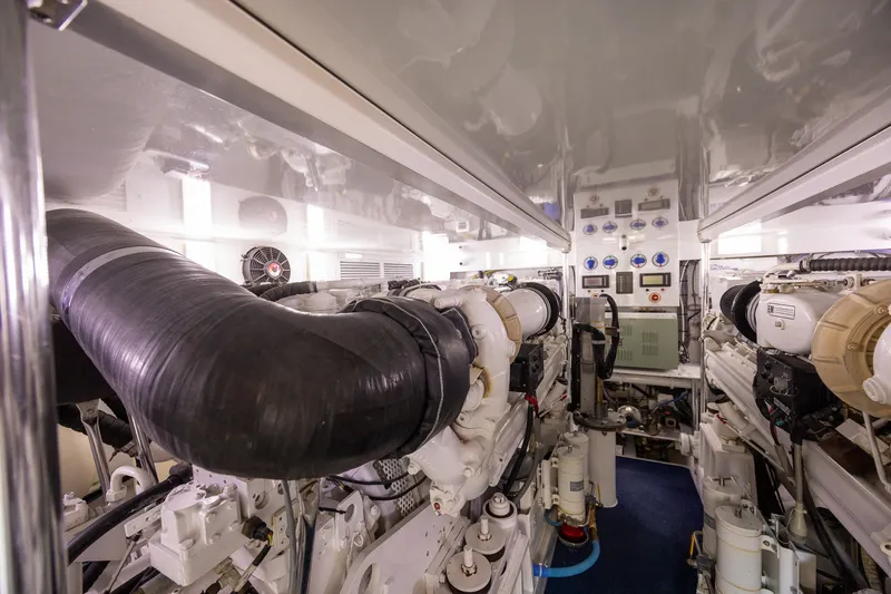 Slide: The Image of Engine room of a 2008 B&D Convertible yacht, featuring complex machinery and control panels. - 68