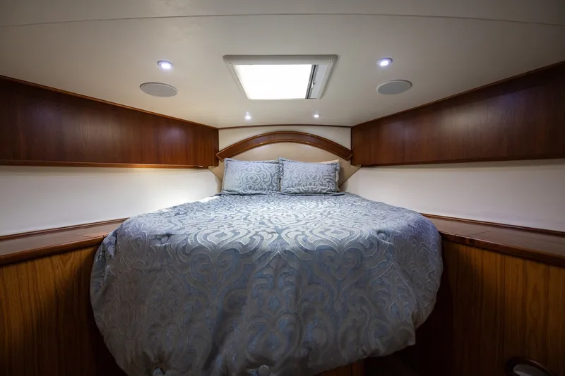 Slide: The Image of Luxurious cabin interior of 2008 B&D Convertible with elegant bedding and wood accents. - 48