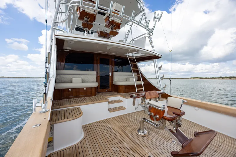 Slide: The Image of Luxury 2008 B&D Convertible yacht with wooden deck and fishing chair on open water. - 14