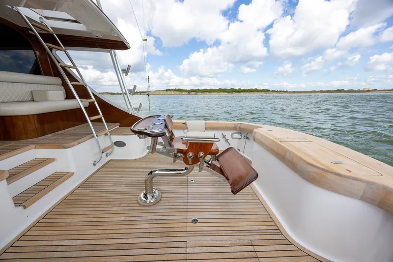 Slide: The Image of Luxury yacht deck with fishing chair, wooden flooring, and ocean view, B&D Convertible 2008 model. - 19