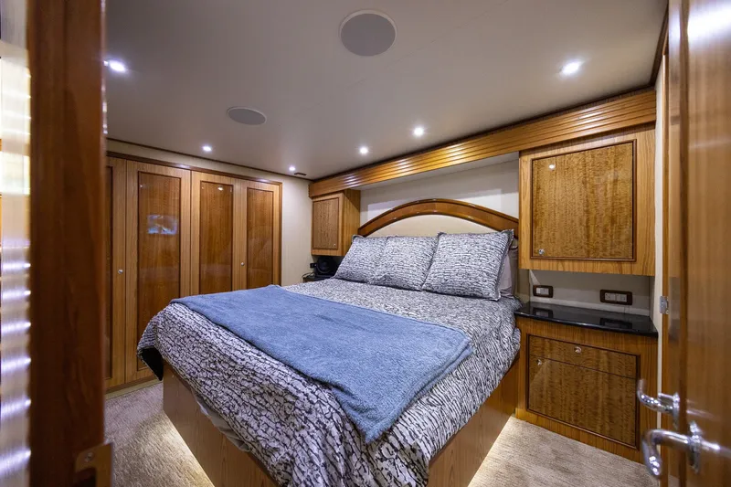 Slide: The Image of Luxurious bedroom interior in a 2008 B&D Convertible yacht, featuring elegant wood finishes. - 36
