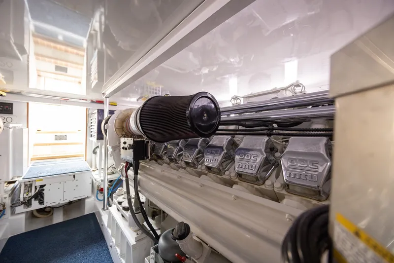 Slide: The Image of Engine room of a 2008 B&D Convertible yacht, showcasing a powerful MTU engine. - 63
