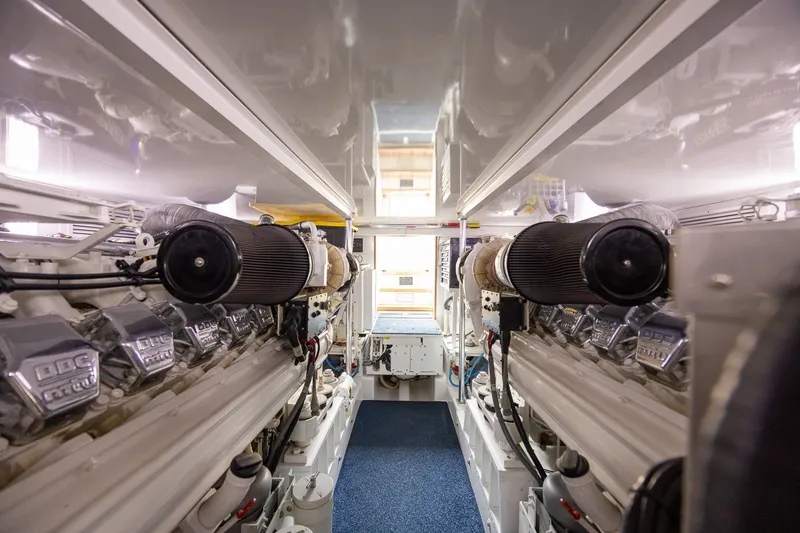 Slide: The Image of Engine room of a 2008 B&D Convertible yacht, showcasing dual engines and mechanical components. - 65