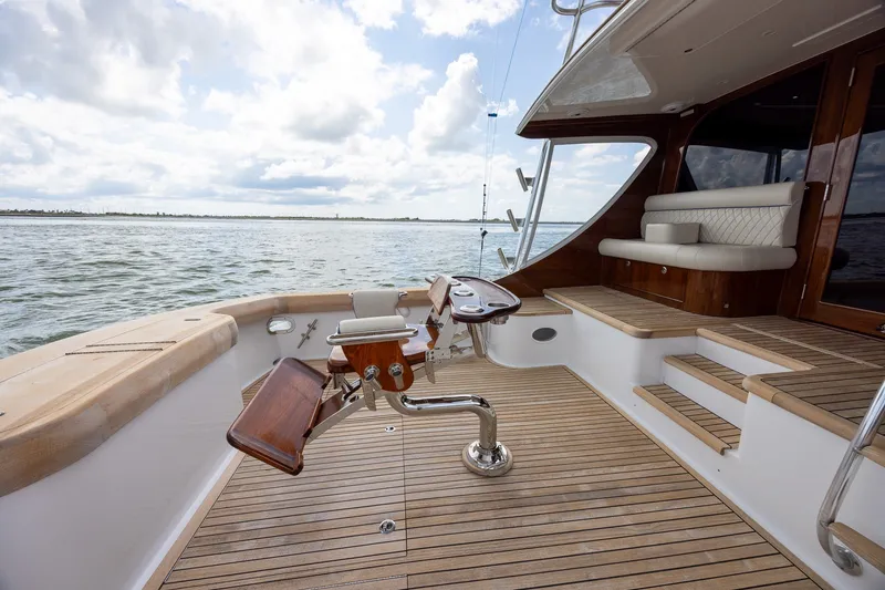 Slide: The Image of Luxurious 2008 B&D Convertible yacht deck with seating, overlooking serene waters. - 18