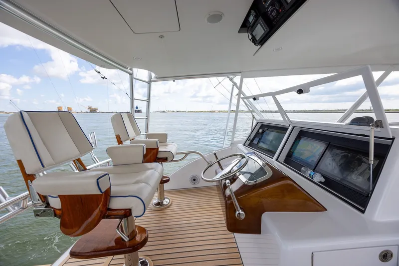 Slide: The Image of Luxurious 2008 B&D Convertible yacht helm with plush seating and advanced navigation systems. - 55