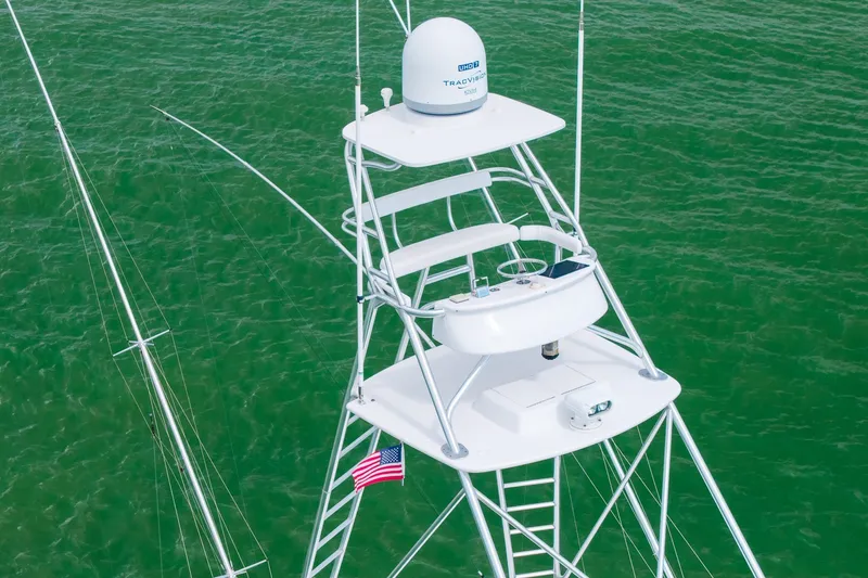 Slide: The Image of Tower of 2008 B&D Convertible boat with radar and American flag over green water. - 11