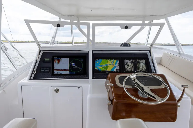 Slide: The Image of Helm of 2008 B&D Convertible boat with navigation screens and steering wheel. - 56