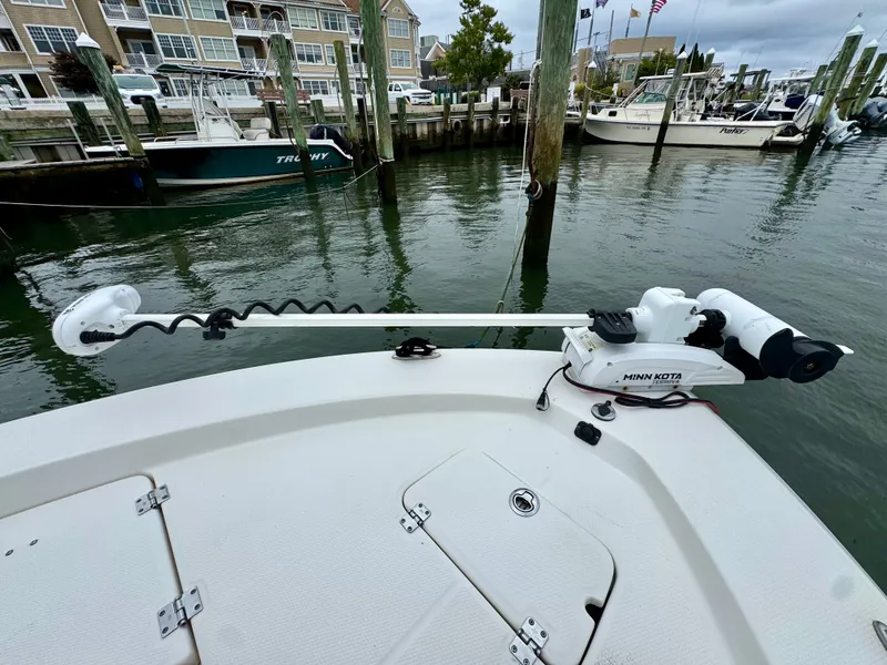 Slide: The Image of A 2015 Robalo 206 Cayman is docked. A Minn Kota trolling motor is mounted. - 17