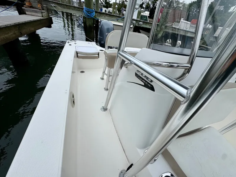 Slide: The Image of The image shows the deck of a 2015 Robalo 206 Cayman boat docked at a pier. - 10