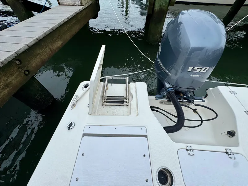 Slide: The Image of The image shows the stern of a 2015 Robalo 206 Cayman boat with a Yamaha 150 engine. - 9