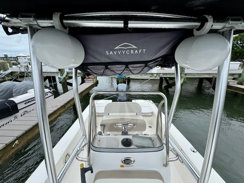 Slide: The Image of The image shows the cockpit of a 2015 Robalo 206 Cayman with T-top and helm console. - 18