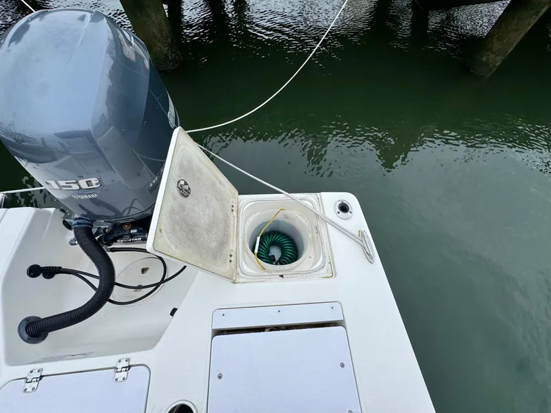 Slide: The Image of A 2015 Robalo 206 Cayman with an outboard motor and an open storage compartment at the stern. - 8