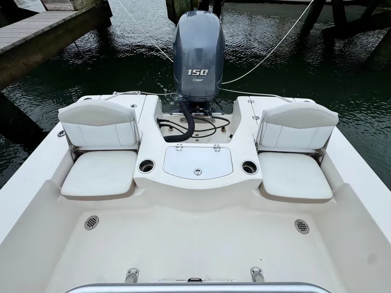 Slide: The Image of The image shows the stern of a 2015 Robalo 206 Cayman with a 150 HP outboard motor. - 6