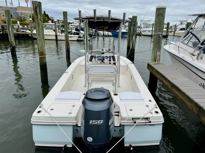 Slide: The Image of A 2015 Robalo 206 Cayman boat docked. It features an outboard motor. - 2
