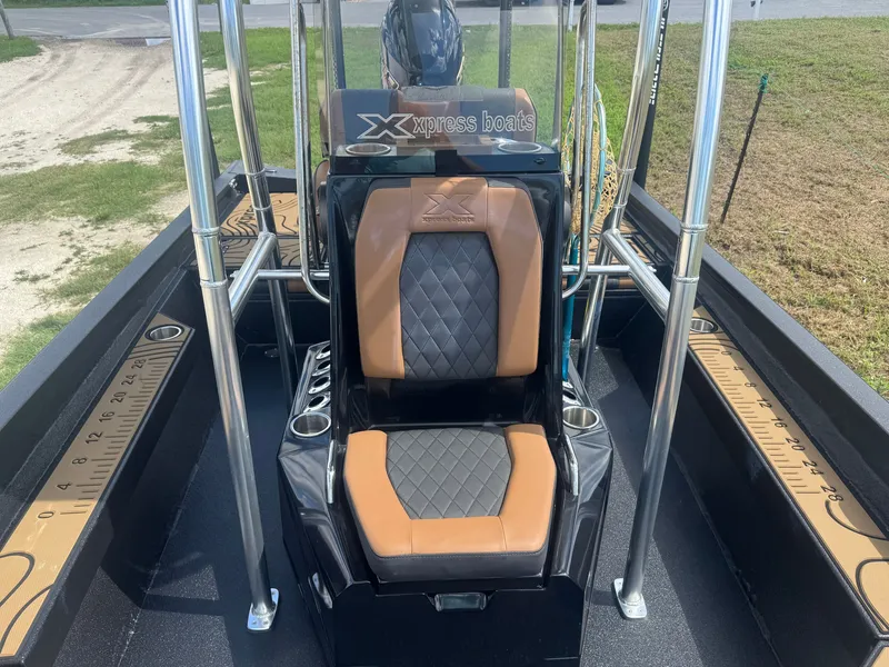 Slide: The Image of The image shows the seating area of a 2026 Xpress H22 boat with cushioned seats. - 7