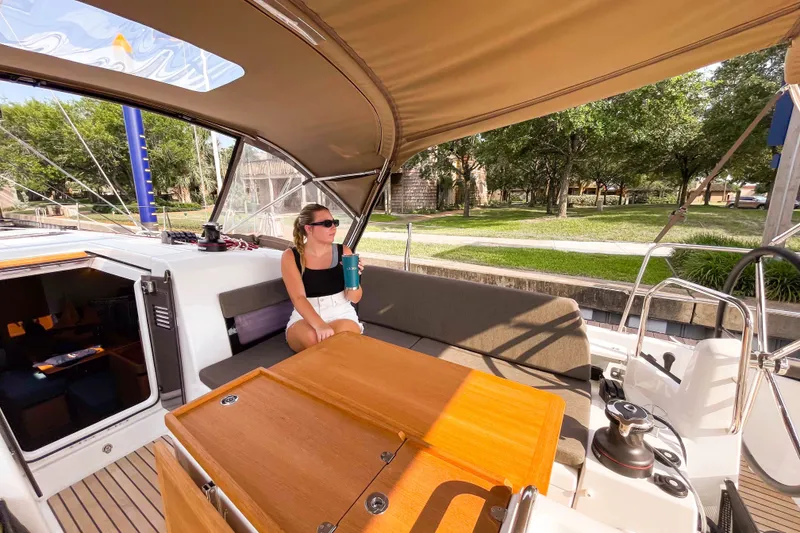 Slide: The Image of Woman relaxing on a 2023 Jeanneau Sun Odyssey 440 sailboat, enjoying a sunny day. - 12