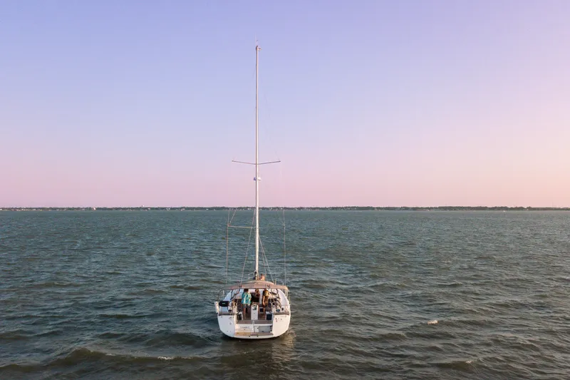 Slide: The Image of 2023 Jeanneau Sun Odyssey 440 sailing on calm waters at sunset. - 21