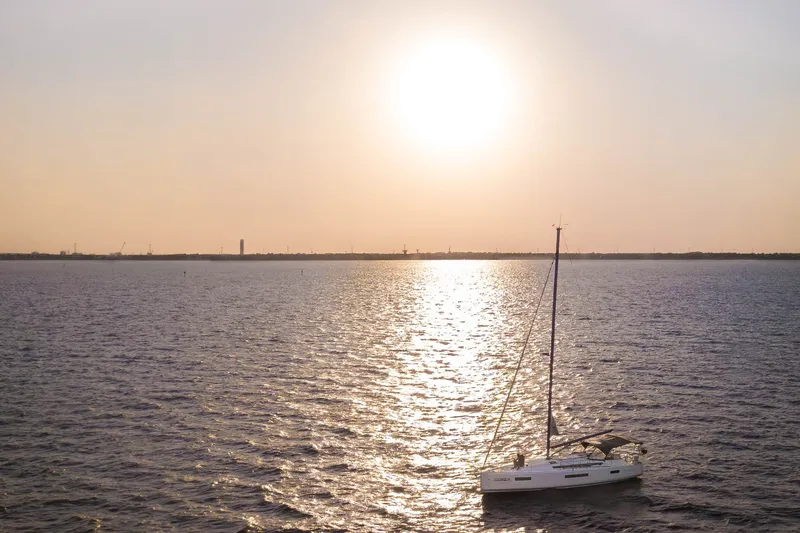 The Image of Sailboat Jeanneau Sun Odyssey 440, 2023 model, cruising at sunset on open water. - 0