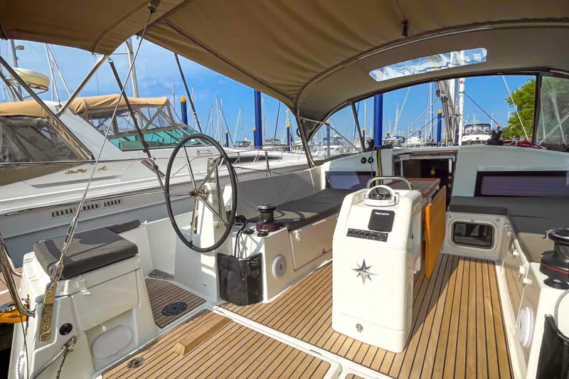 Slide: The Image of 2023 Jeanneau Sun Odyssey 440 yacht interior with steering wheel and seating area. - 10