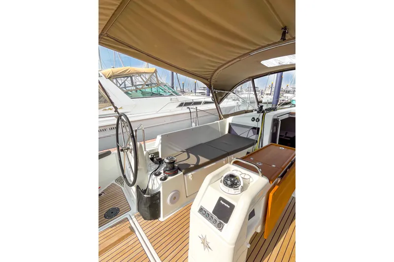 Slide: The Image of Cockpit of 2023 Jeanneau Sun Odyssey 440 sailboat with steering wheel and navigation equipment. - 11