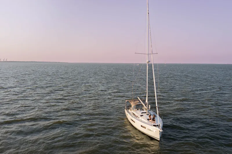 Slide: The Image of 2023 Jeanneau Sun Odyssey 440 sailing on calm ocean waters at sunset. - 4