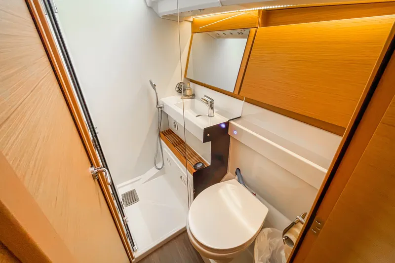 Slide: The Image of Modern bathroom in 2023 Jeanneau Sun Odyssey 440 yacht, featuring sleek design and wooden accents. - 14