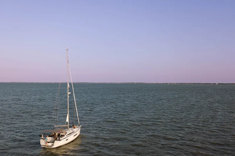 Slide: The Image of Sailboat Jeanneau Sun Odyssey 440, 2023 model, on calm sea under clear sky. - 20