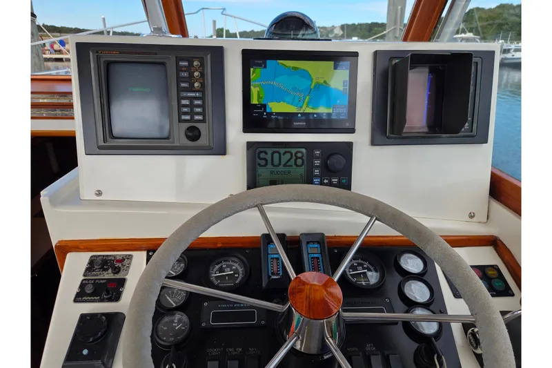 Slide: The Image of Cockpit of 1999 Fortier Express 33 with navigation instruments and steering wheel. - 13