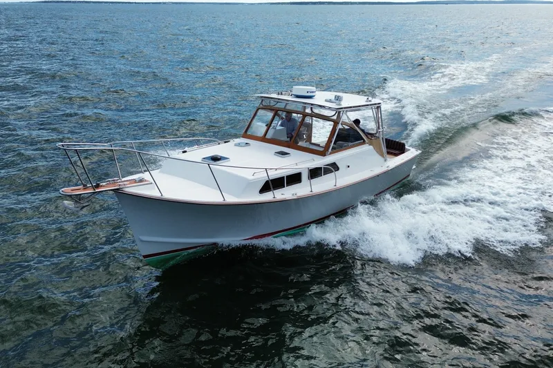 Slide: The Image of 1999 Fortier Express 33 cruising on open water, showcasing sleek design and performance. - 5