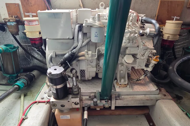 Slide: The Image of Engine room of a 1999 Fortier Express 33 boat, showcasing mechanical components and wiring. - 33