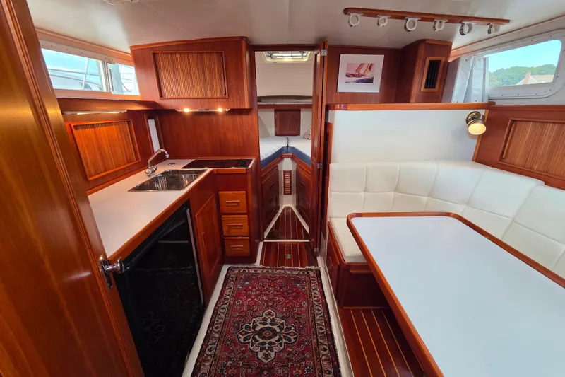 Slide: The Image of Luxurious interior of 1999 Fortier Express 33 yacht with wood finishes and cozy seating area. - 20