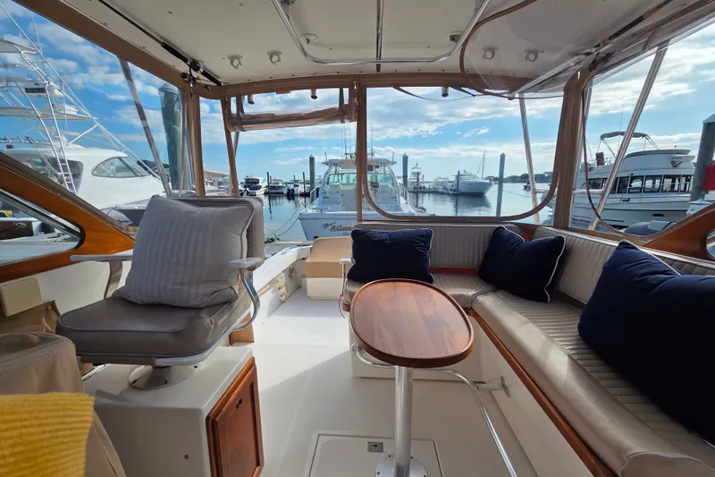 Slide: The Image of Interior of 1999 Fortier Express 33 yacht with seating and marina view. - 15