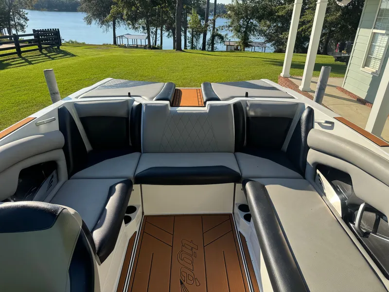 Slide: The Image of L'immagine mostra il cockpit di una barca Tigé R23 del 2018 con sedili eleganti e pavimento in legno. - 9
