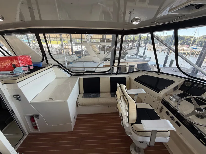Slide: The Image of The cockpit of a 1991 Hatteras 52 Cockpit Motor Yacht with helm and seating area. - 20