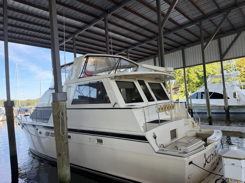 Slide: The Image of A 1991 Hatteras 52 Cockpit Motor Yacht docked in a covered marina. - 1