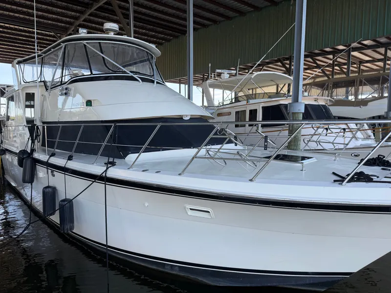 Slide: The Image of A 1991 Hatteras 52 Cockpit Motor Yacht docked in a covered marina. - 9