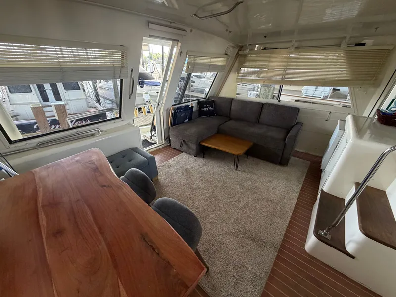 Slide: The Image of Interior of a 1991 Hatteras 52 Cockpit Motor Yacht with sofa, table, and carpet. - 16