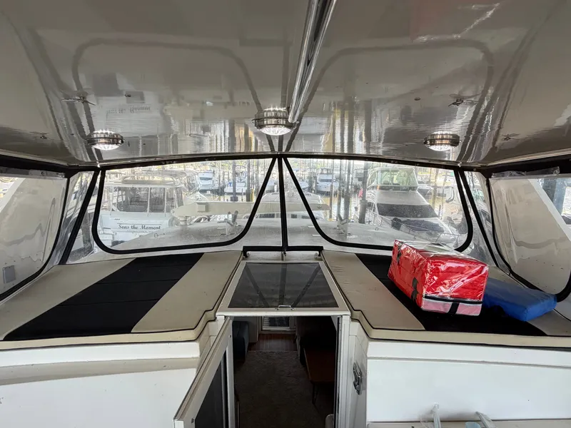 Slide: The Image of The cockpit of a 1991 Hatteras 52 Cockpit Motor Yacht with clear windows and seating. - 28
