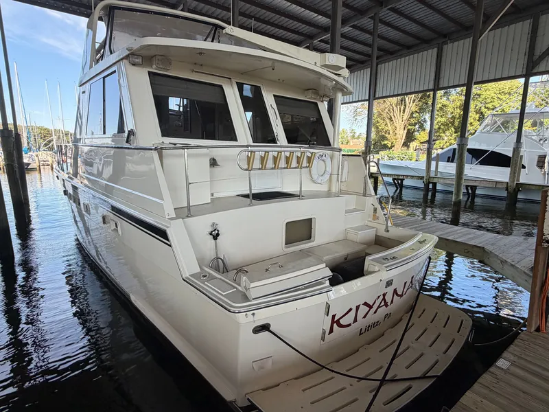 Slide: The Image of A 1991 Hatteras 52 Cockpit Motor Yacht docked in a covered marina. - 3