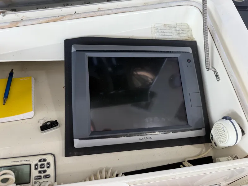 Slide: The Image of A Garmin navigation system is installed in a cockpit, surrounded by a radio and a notebook. - 24
