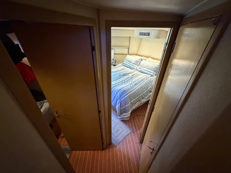 Slide: The Image of A cozy bedroom with striped bedding and wooden flooring on a yacht. - 49