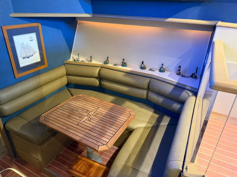 Slide: The Image of A cozy seating area with a wooden table and cushioned benches, decorated with miniature lighthouses. - 40
