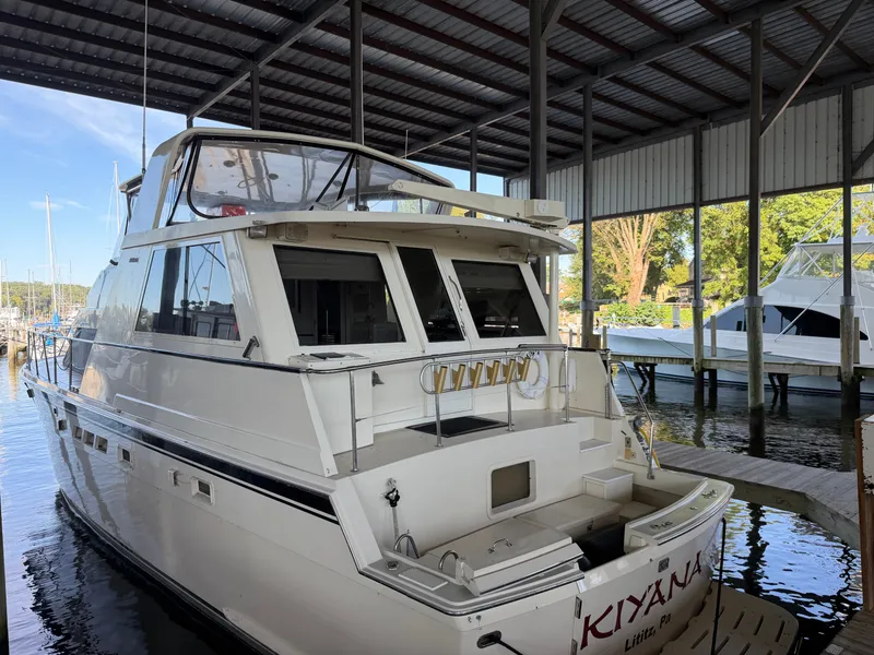 Slide: The Image of A 1991 Hatteras 52 Cockpit Motor Yacht docked in a covered marina. - 2
