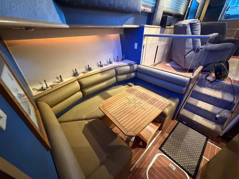 Slide: The Image of Interior of a 1991 Hatteras 52 Cockpit Motor Yacht with a cozy seating area and wooden table. - 41