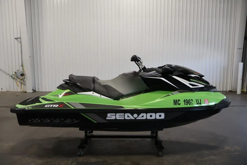 Slide: The Image of 2018 Sea-Doo GTR-X 230 jet ski in vibrant green, displayed indoors. - 5