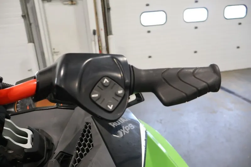 Slide: The Image of 2018 Sea-Doo GTR-X 230 handlebar with control buttons in a garage setting. - 10