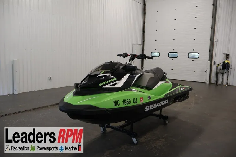 The Image of 2018 Sea-Doo GTR-X 230 jet ski in a showroom, green and black design. - 1