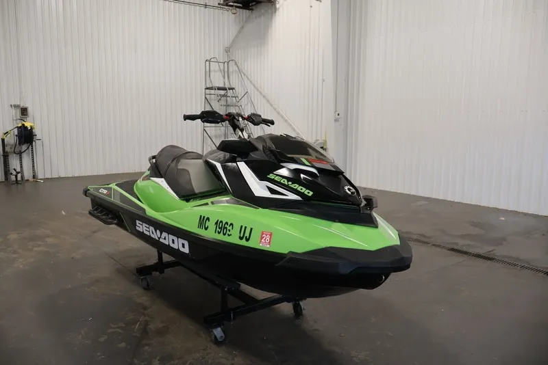 Slide: The Image of 2018 Sea-Doo GTR-X 230 jet ski in a garage, vibrant green and black design. - 4