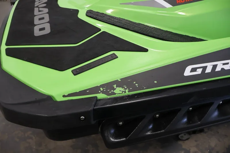 Slide: The Image of 2018 Sea-Doo GTR-X 230, green and black, close-up view with minor paint wear. - 23